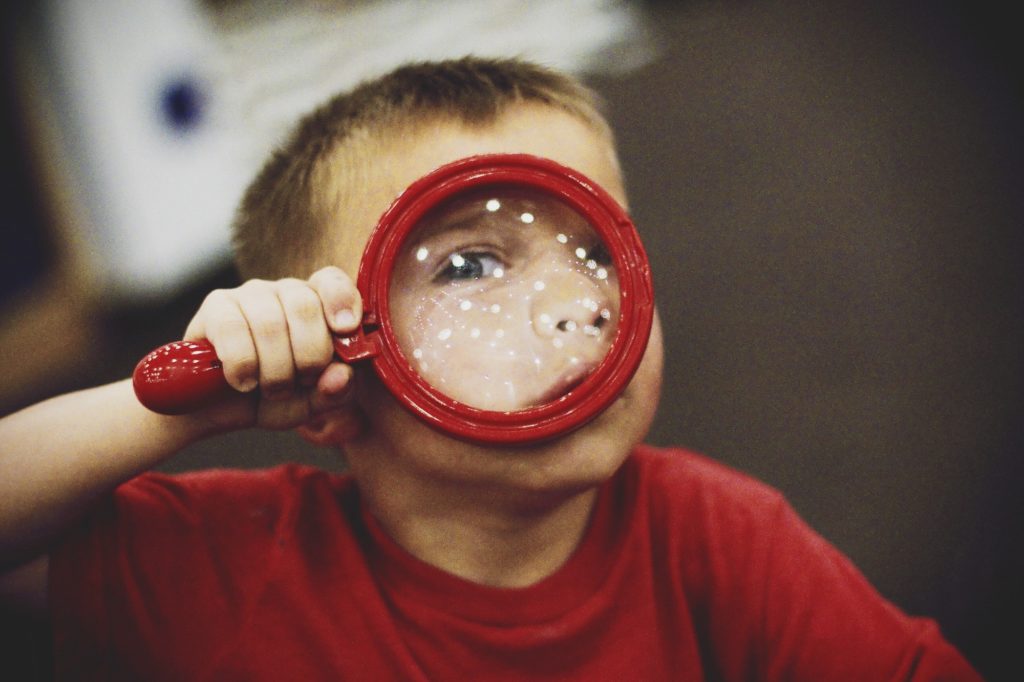 Little boy and magnifying glass
